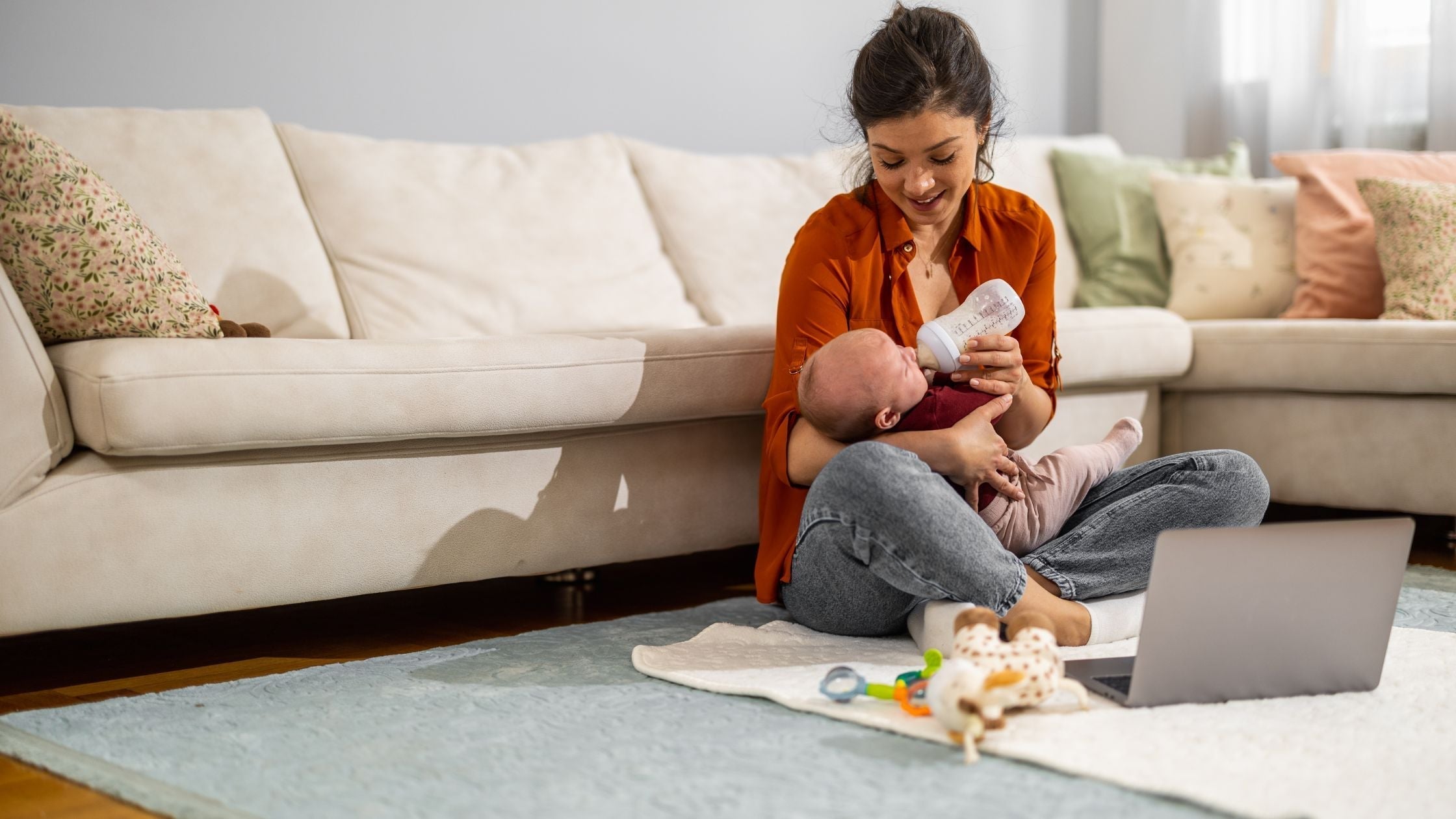 Woman feeding baby with Formula in a bottle | Organic Formula Hub